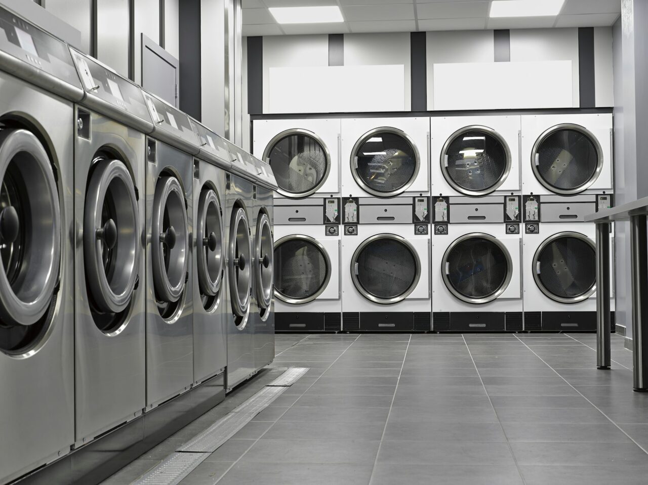 row-of-industrial-washing-machines-in-a-public-laundromat.jpg